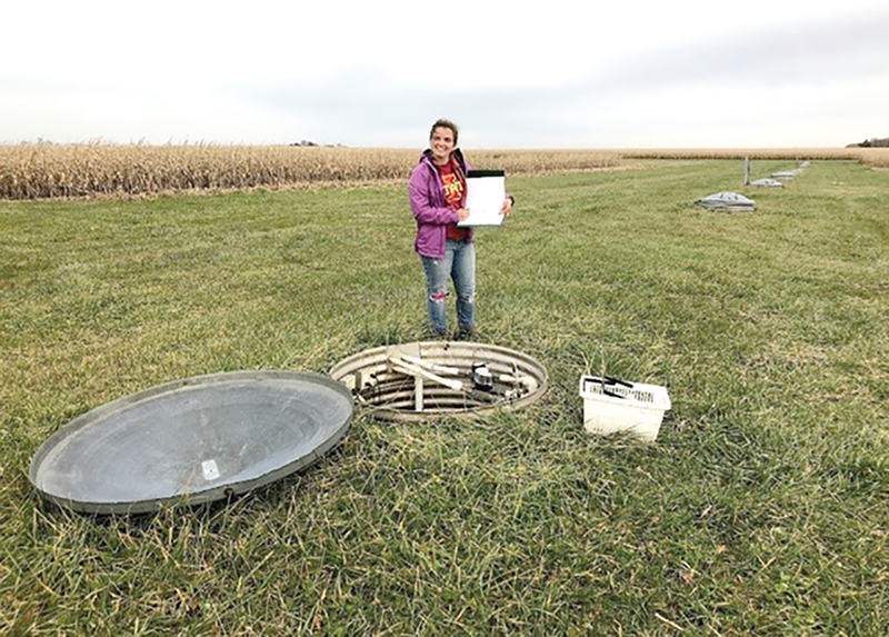 Emily Waring collecting water samples at the field site near Gilmore City, IA. Photo courtesy of Emily Rose Waring.