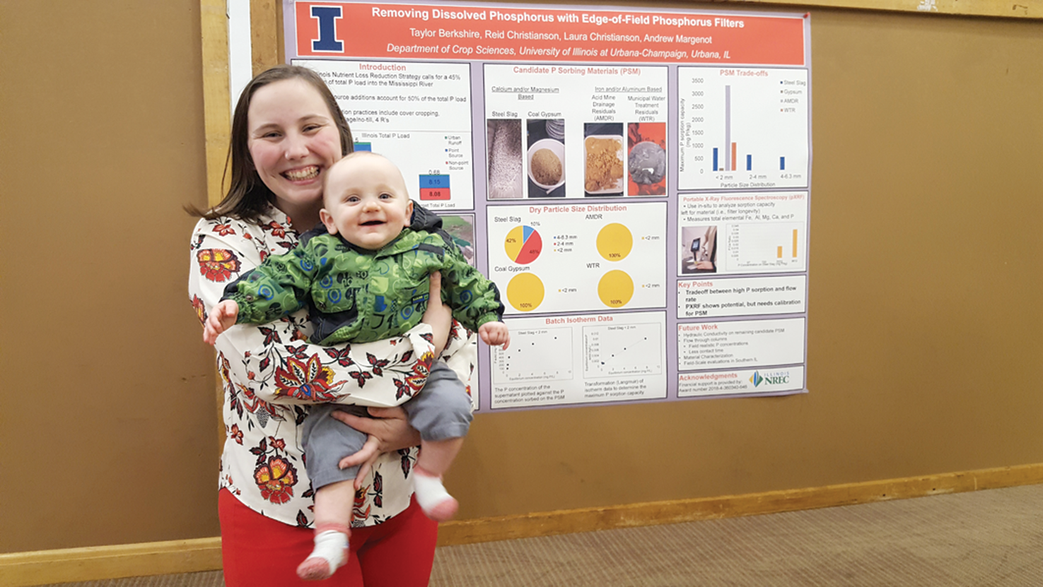 Graduate student Taylor Berkshire with her son after presenting her research at a workshop to stakeholders and other researchers.