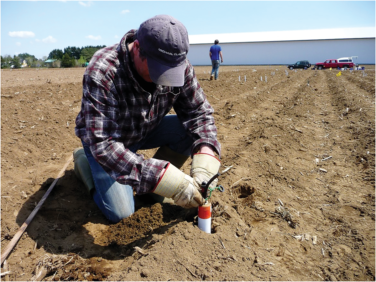 Dr. Athyna Cambouris's research team member installing a suction lysimeter during a field experiment in Quebec, Canada. Photo by Athyna Cambouris.