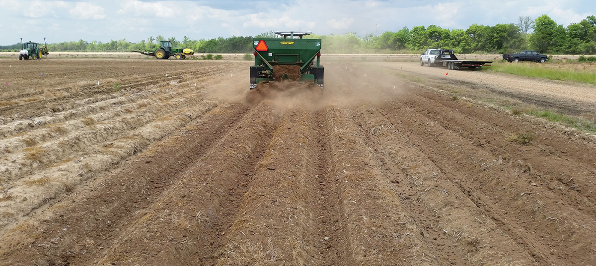 Application of poultry litter with a small-plot manure spreader in a study that investigated methods of managing nutrient buildup due to repeated poultry litter applications. Photo by H. Tewolde.