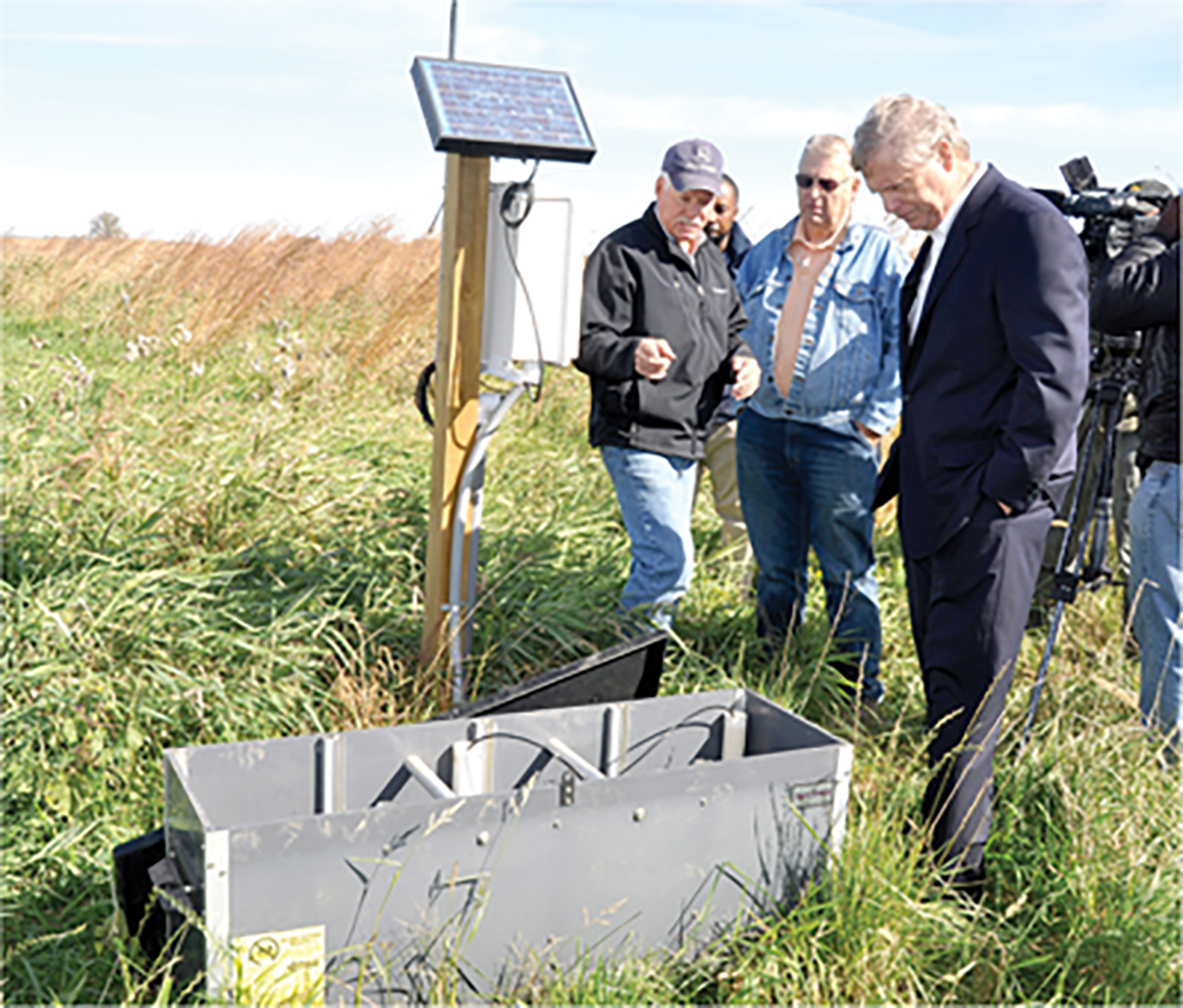 Iowa farmer Nick Meier talks to Agriculture Secretary Tom Vilsack (right) and La Porte City, IA, Mayor Buck Clark during a tour to view water quality conservation practices on Meier’s farm in 2015. USDA photo by Jason Johnson.