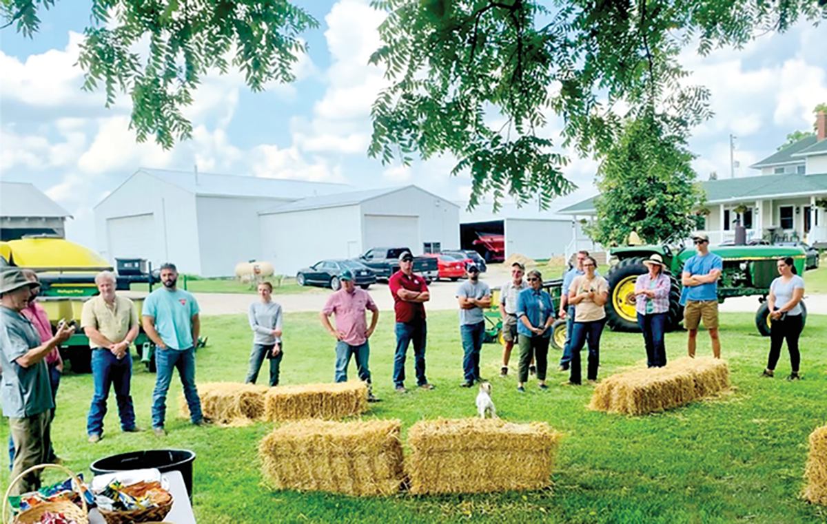 Farmers and agricultural and conservation professionals at a field day in southern Michigan in Jul 2021, discussing innovative cropping practices, including relay planting, interseeding cover crops into corn, and “planting green.” Photo by Julie E. Doll.