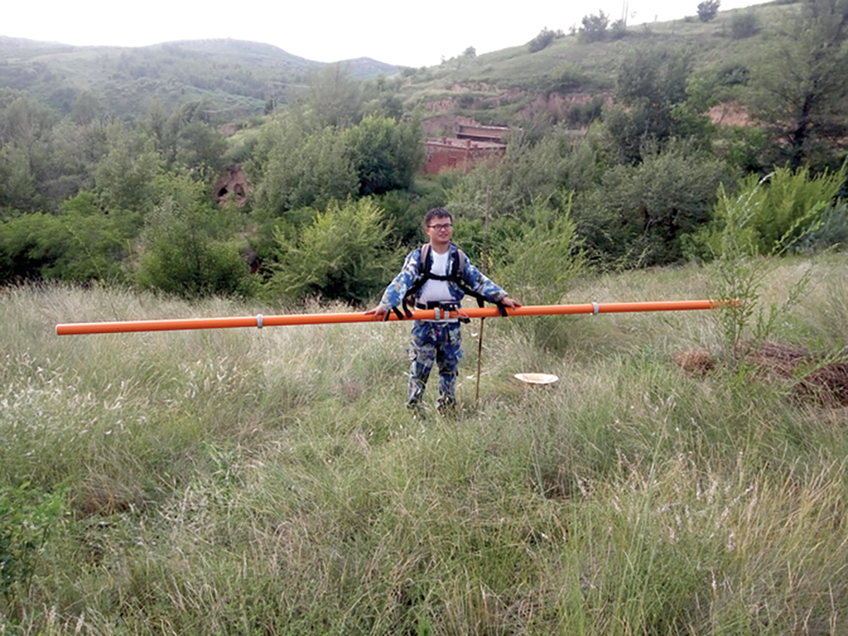 Study author Qinbo Cheng carries an electromagnetic induction (EMI) explorer, which the team used to obtain soil bulk electrical conductivity data. Photo by Jiao Wang.