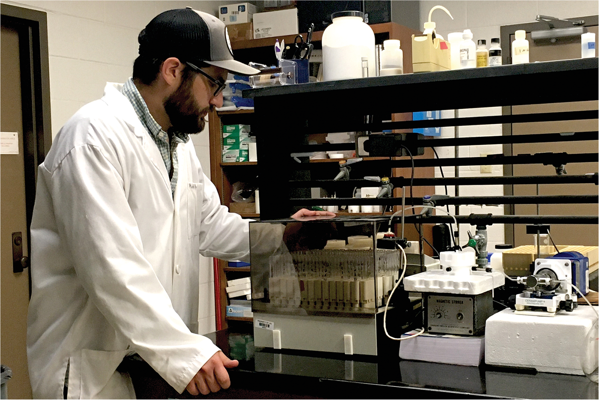 Lead author Josh Padilla monitors a sorption kinetics experiment like those done in this study. Photo by Easton Padilla.