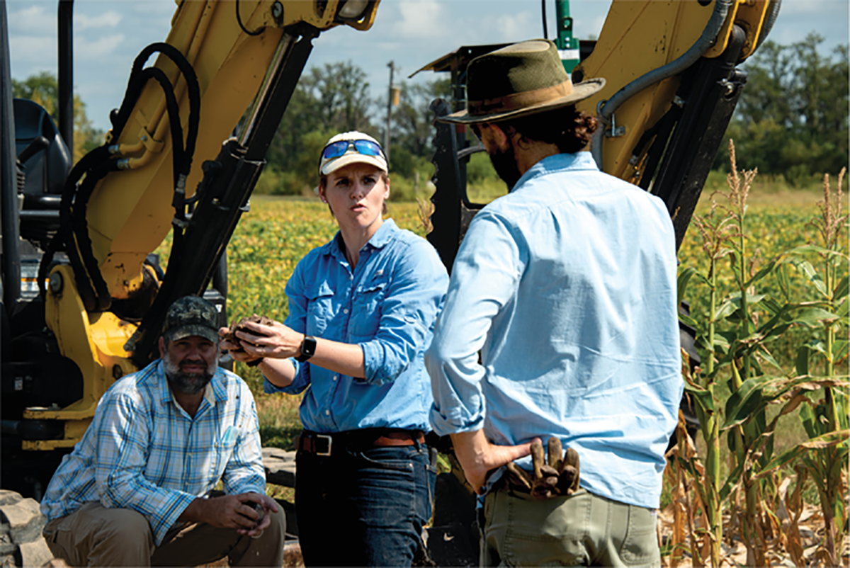 First author Dianna Bagnall (center) talks about soil structure with a field supervisor and plant scientist. Photo by Bill Stutz.