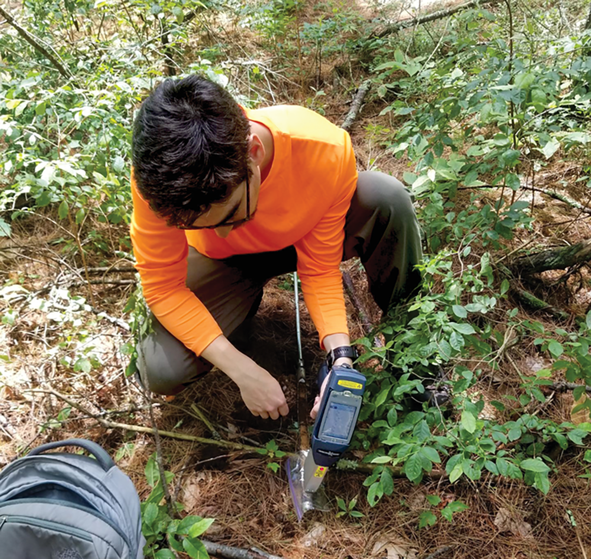 First author Mark Higgins measuring arsenic and lead levels in soils at depth using an X-ray fluorescence device and soil probe. Photo courtesy of Meredith Metcalf.