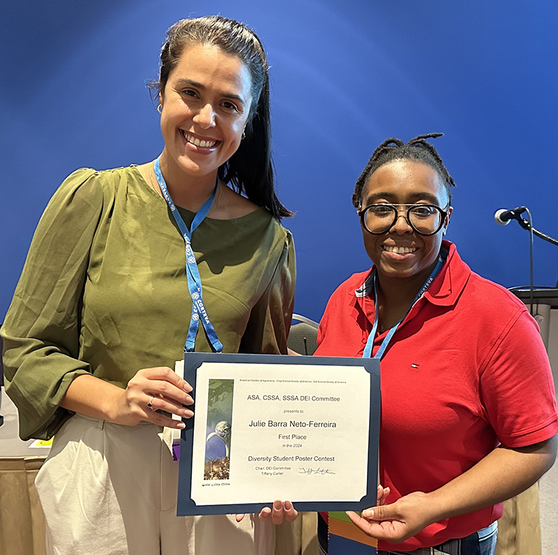 Julia Barra-Netto Ferreira (left), first-place winner of the 2024 Diversity Student Poster ContestÂ  and Tiffany Carter, 2024 chair of the Diversity, Equity, and Inclusion Committee.