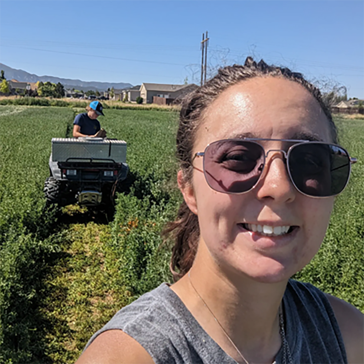 Tina Sullivan smiles while her team harvests alfalfa plots in Cedar City, UT. Both the small grain and alfalfa projects are vital components of the extensive water optimization research she conducted for her master’s and Ph.D.