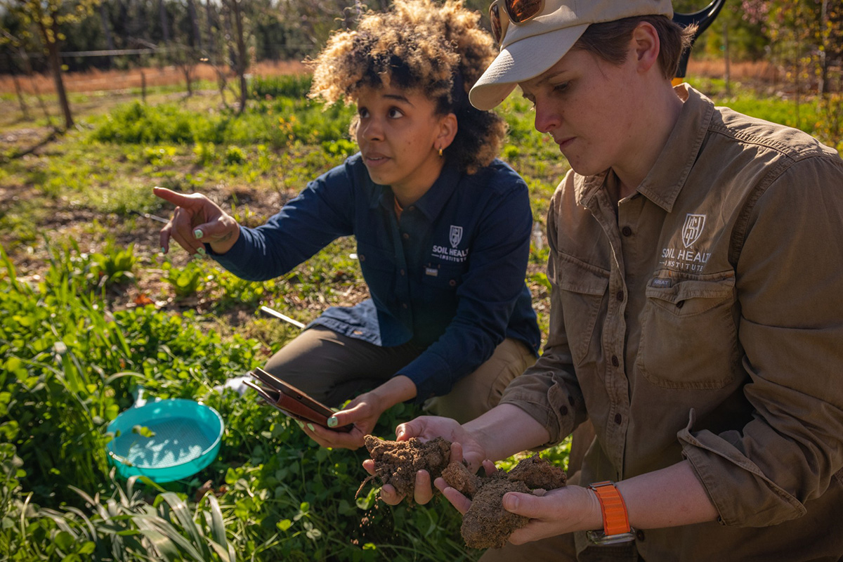 Dianna Bagnall (right) examines soil during a field visit with a colleague from the Soil Health Institute (SHI). Photo courtesy of Dianna Bagnall.