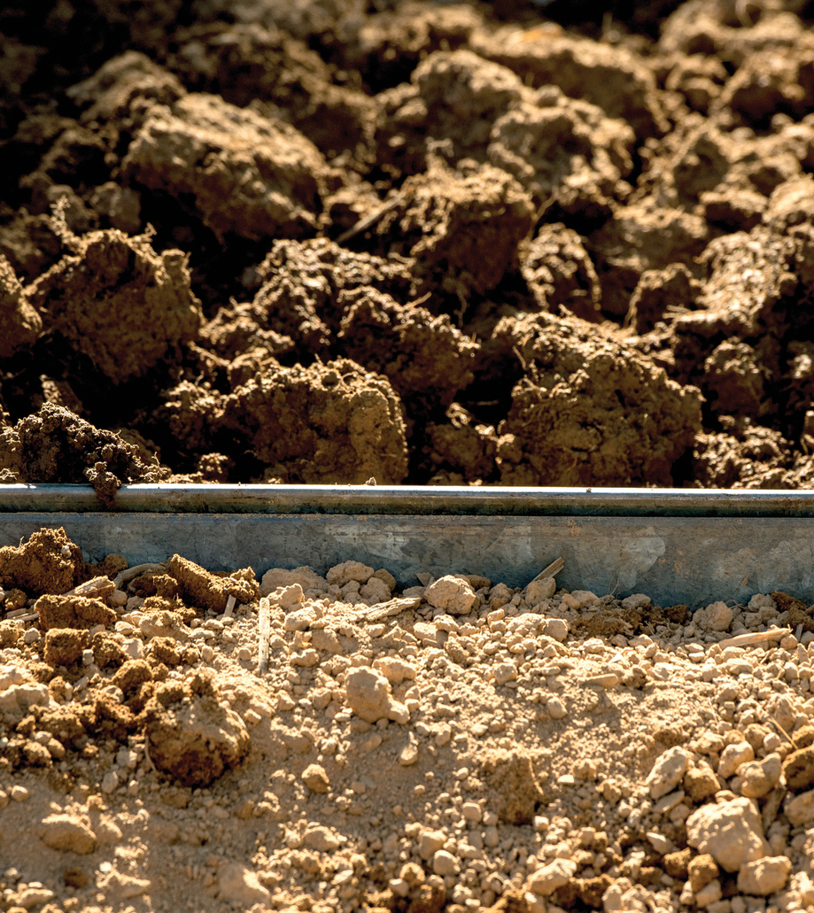 Under industrial agricultural practices, like the use of heavy machinery, soil structure is compromised and microbial diversity weakened. This, in turn, affects agricultural produc- tivity. Here healthy moist soil (above) is contrasted with dry compacted soil (below). USDA Photo by Lance Cheung.