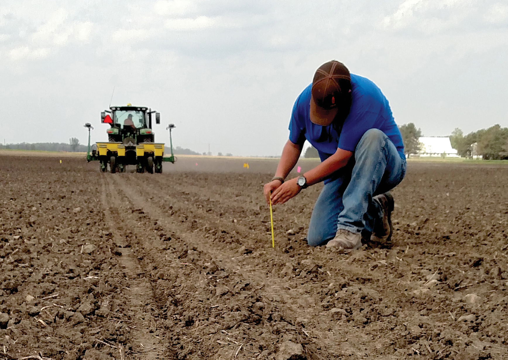 Checking seeding depth. Photo by Alexander Lindsey.