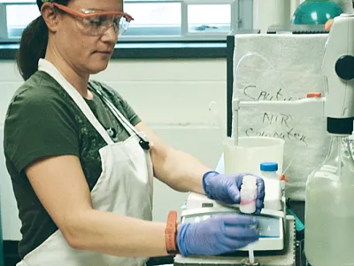 Lab technician, Erin Silva, prepares a sample for titration with hydrochloric acid to determine the amount of CO2 released by soil during incubation as part of soil-test biological activity to predict soil nitrogen mineralization. Photo by Alan Franzluebbers, USDA-ARS.
