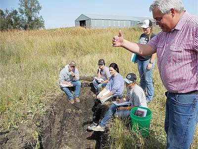 Dickinson State University students learn to describe soils in the field in 2018. Photo by Cindy Burgess, Dickinson State University.