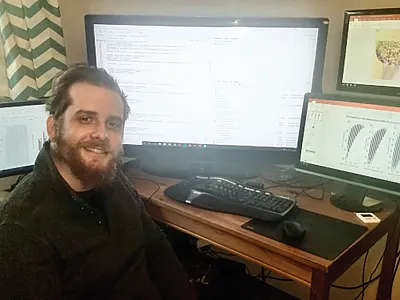 Nick Ames analyzing DNA and field-performance data to determine how genomewide predictions can reduce field testing in maize.