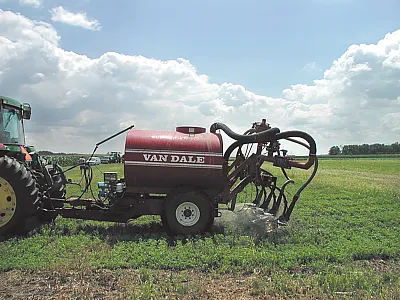 Swine manure is sprayed on growing alfalfa with a research-scale manure applicator. Photo by Joann Lamb.