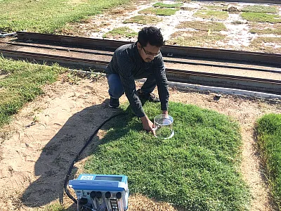 Ph.D. student Krishna Katuwal taking gas exchange measurements on turfgrass plants. Photo by Viktor Tishchenko.