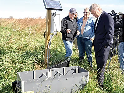 Iowa farmer Nick Meier talks to Agriculture Secretary Tom Vilsack (right) and La Porte City, IA, Mayor Buck Clark during a tour to view water quality conservation practices on Meier’s farm in 2015. USDA photo by Jason Johnson.