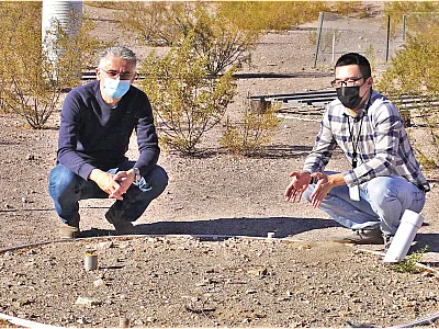 Drs. Yuan Luo (right) and Markus Berli (left) discussing the soil surface of SEPHAS Lysimeter 1 at the Desert Research Institute in Boulder City, NV. Photo by Ali Swallow, Desert Research Institute.