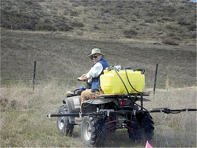 Rusty Rodriguez, CEO of Adaptive Symbiotic Technologies, applies his company’s commercial fungal endophyte inoculant to a field. Photo courtesy of Rusty Rodriguez.