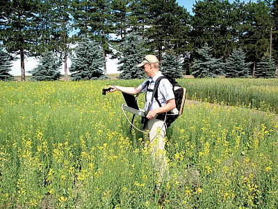 Remote-sensing scientist John Sulik uses a high-spectral-resolution sensor to record hundreds of wavelengths of light to understand which combinations are most effective for estimating the number of flowers per square meter and final seed yield. Photo courtesy of the USDA-ARS Columbia Plateau Conservation Research Station in Adams, OR.