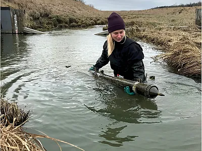 Emptying a fluvial suspended sediment sampler in one of the streams. Photo by Mikael Östlund.