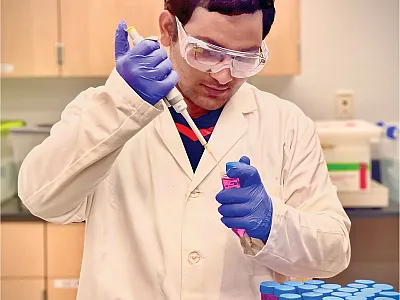 Graduate student Binaya Parajuli analyzing active carbon concentrations in soil extracts. Photo by Pratima Poudel.