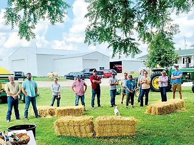 Farmers and agricultural and conservation professionals at a field day in southern Michigan in Jul 2021, discussing innovative cropping practices, including relay planting, interseeding cover crops into corn, and “planting green.” Photo by Julie E. Doll.