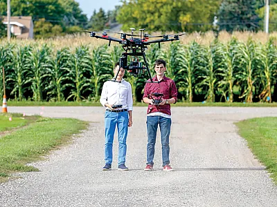 University of Minnesota (UMN) researchers test a drone equipped with sensing equipment that will be used to collect data to monitor crop health and growth. Photo courtesy of the UMN photo archive.