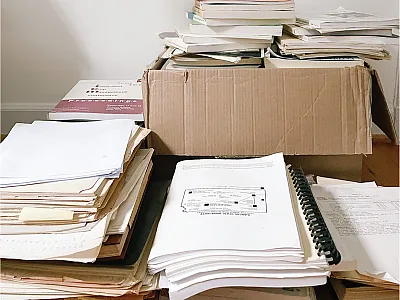 <em>Piles of old physical files that contain legacy data to be preserved in the FRST database and used in the decision support tool. Much of the original correlation/calibration work conducted around the U.S. is unpublished, not digitized, and risks being thrown away as soil fertility faculty retire and empty their filing cabinets. The FRST team is collecting as much of this data as possible from both electronic and physical files from soil fertility faculty around the country. </em> Photo by Sarah Lyons.