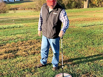 Lead author Jonathan Kubesch, then a graduate student at the University of Tennessee, measures tall fescue. Photo courtesy of Marcia Quinby.