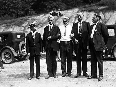 A transcontinental field tour was organized as part of the First International Congress of Soil Science, held June 13-22, 1927, in Washington, DC. This photo appears to be a field or group setting during the tour and shows Curtis F. Marbut (second from left, a U.S. pedologist who guided much of the tour) and Konstantin Glinka (middle, from the Soviet Union). 