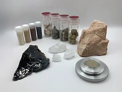 Mineral samples used as standards for fitting of X-ray powder diffraction (XRPD) data, including biotite (trioctahedral mica; black platy mineral at lower left). Details of the method are described in Kurokawa et al. (2025). Photo courtesy of Kohei Kurokawa, Kyoto Prefectural University.