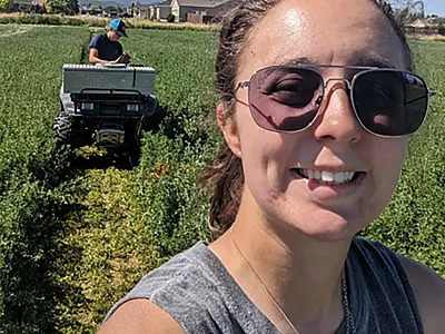 Tina Sullivan smiles while her team harvests alfalfa plots in Cedar City, UT. Both the small grain and alfalfa projects are vital components of the extensive water optimization research she conducted for her master’s and Ph.D.