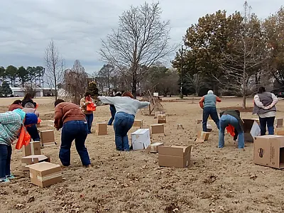 4-H Youth Development Agents test drive the activity "Flipping Stones," a lesson on fish feeding adaptions where they are mimicking darter fish. Photo by Andrea Ludwig.