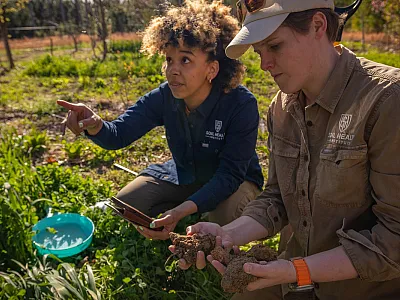 Dianna Bagnall (right) examines soil during a field visit with a colleague from the Soil Health Institute (SHI). Photo courtesy of Dianna Bagnall.