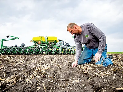 Iowa farmer Jeff Frank checks the quality of soybean planting after using the online simulator. Photo by Joseph L. Murphy/Iowa Soybean Association.