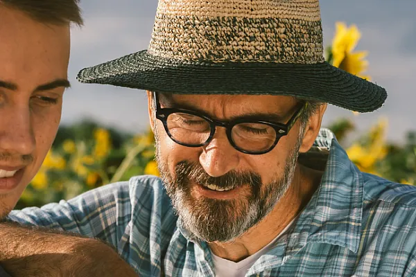 people interacting in a field of sunflowers