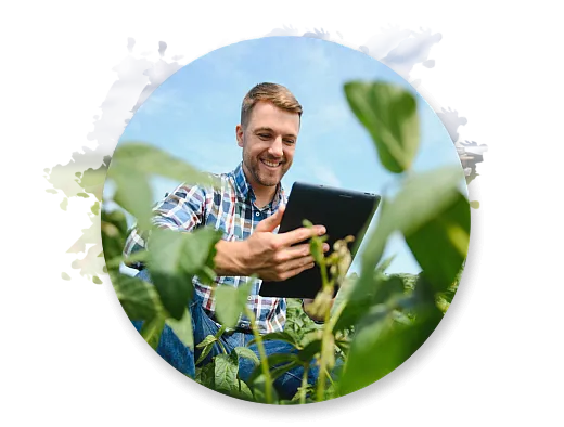 man in a field with a hand held device