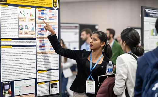 student presenting research poster at CANVAS