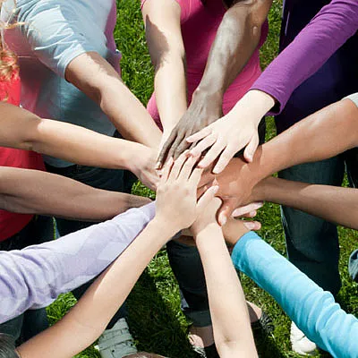 groups of hands coming together: community