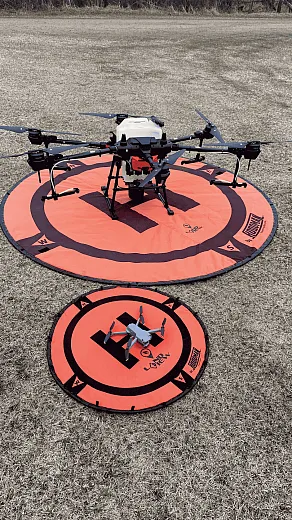 Drones come in all sizes. The small drone is the DJI Air 2S, which is used for observing crops. The large drone is the DJI Agras T20 spray and spread. Photo courtesy of Markus Weber, LandView Drones.